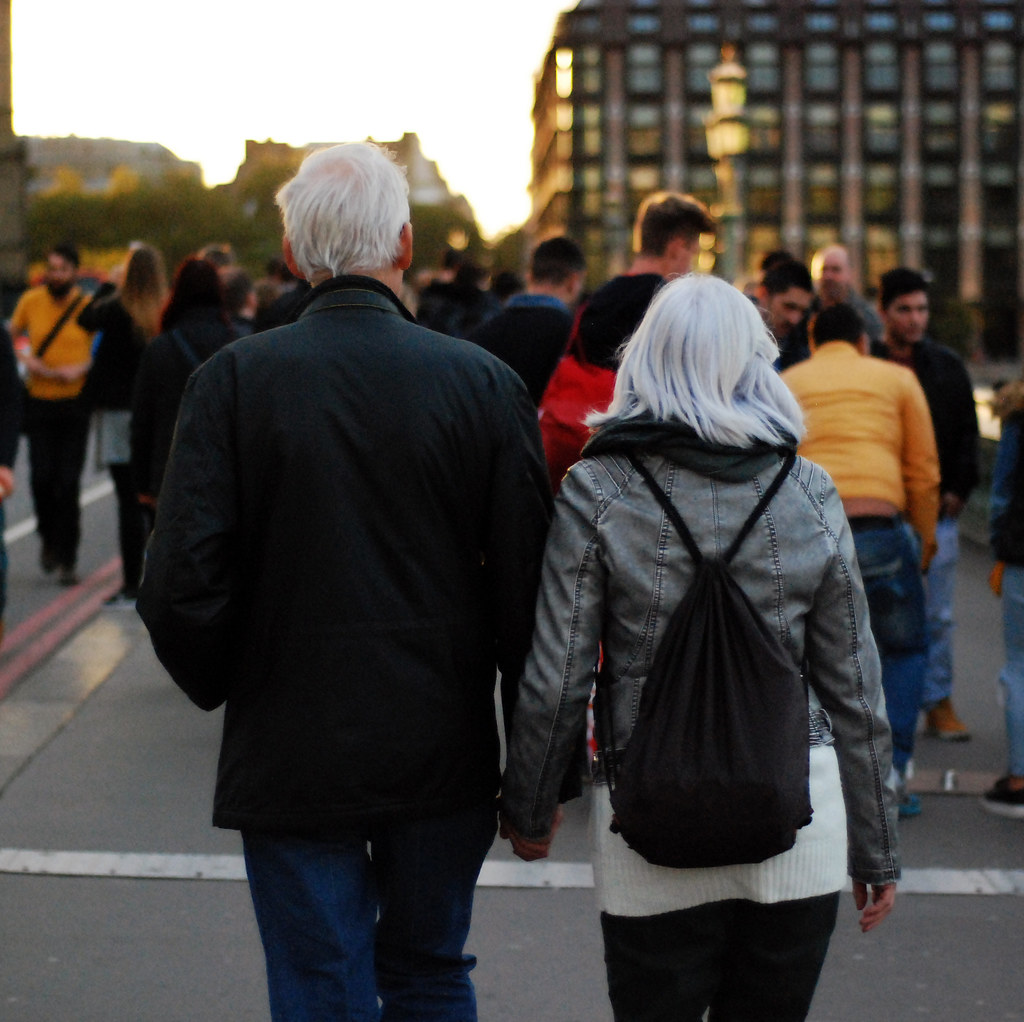 husband and wife walking through city